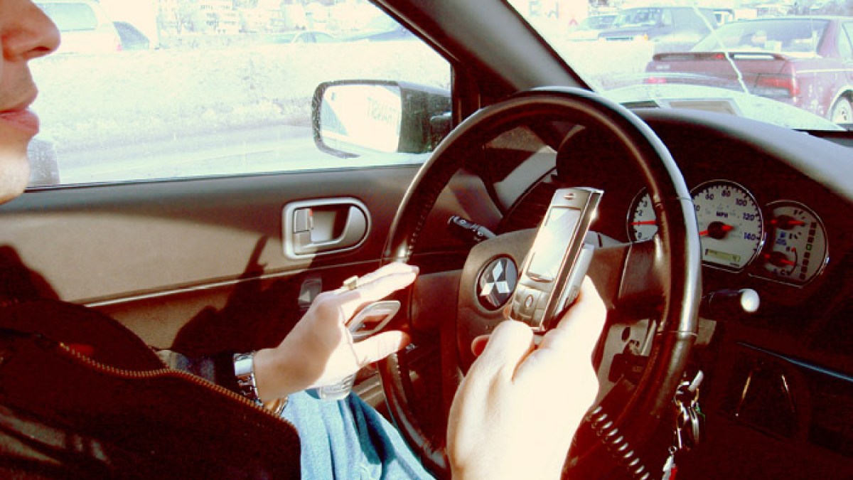 hand_held_phone_in_car.jpg hand_held_phone_in_car.jpg