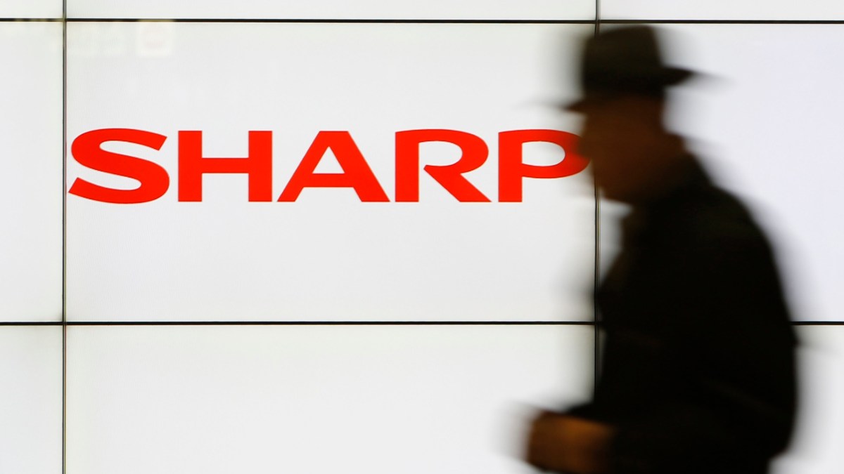 A pedestrian walks past a logo of Sharp Corp at a train station in Tokyo in this February 3, 2014 file photo. Embattled Japanese electronics maker Sharp Corp is preparing to seek aid from its two main lenders, a source with direct knowledge of the matter said, as it expects impairment losses from unprofitable businesses to mount this year. REUTERS/Yuya Shino/Files (JAPAN - Tags: BUSINESS LOGO) A pedestrian walks past a logo of Sharp Corp at a train station in Tokyo in this February 3, 2014 file photo. Embattled Japanese electronics maker Sharp Corp is preparing to seek aid from its two main lenders, a source with direct knowledge of the matter said, as it expects impairment losses from unprofitable businesses to mount this year. REUTERS/Yuya Shino/Files (JAPAN - Tags: BUSINESS LOGO)