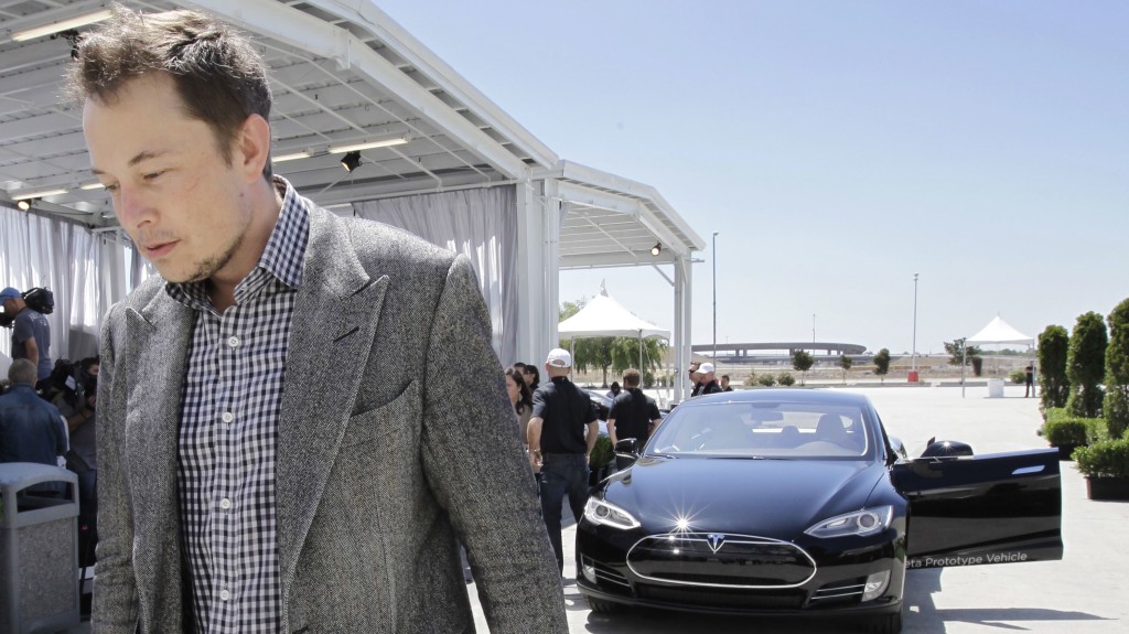 Tesla CEO Elon Musk walks past the Tesla Model S after a news conference at the Tesla factory in Fremont, Calif., Friday, June 22, 2012. The first Model S sedan car will be rolling off the assembly line on Friday. (AP Photo/Paul Sakuma) Tesla CEO Elon Musk walks past the Tesla Model S after a news conference at the Tesla factory in Fremont, Calif., Friday, June 22, 2012. The first Model S sedan car will be rolling off the assembly line on Friday. (AP Photo/Paul Sakuma)