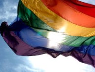 1280px-Rainbow_flag_and_blue_skies