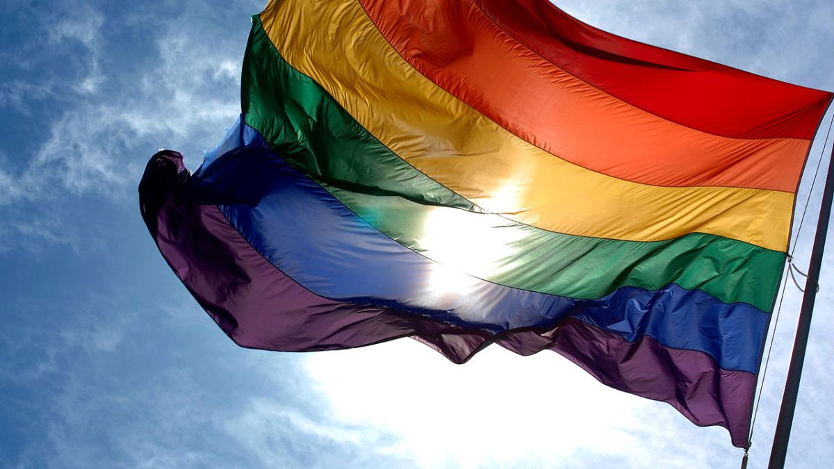 1280px-Rainbow_flag_and_blue_skies 1280px-Rainbow_flag_and_blue_skies