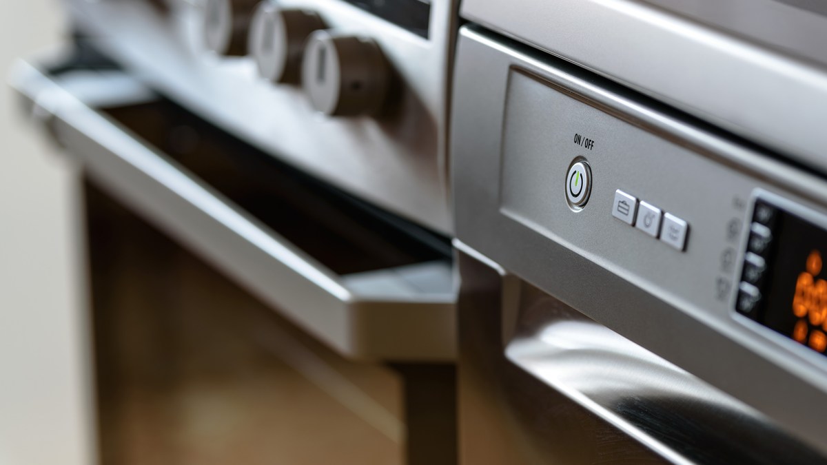 Metallic stove and dishwasher in the kitchen Metallic stove and dishwasher in the kitchen