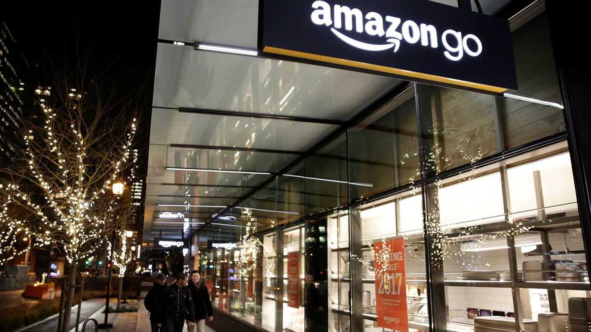 People walk by the Amazon Go brick-and-mortar grocery store without lines or checkout counters, in Seattle Washington People walk by the Amazon Go brick-and-mortar grocery store without lines or checkout counters, in Seattle Washington