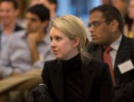 Elizabeth Holmes, the chief executive officer and founder of Theranos, a health care technology company, listens as Deputy Secretary of Defense Ash Carter speaks at Stanford University in Palo Alto, Calif., April 17, 2013. (DoD photo by Glenn Fawcett/Released)