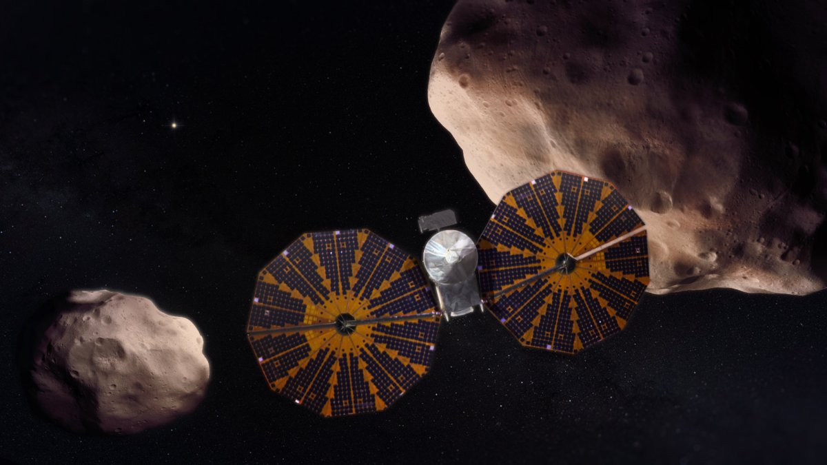 Vue d'artiste de la mission Lucy explorant les astéroïdes troyens. // Source : NASA's Goddard Space Flight Center Vue d'artiste de la mission Lucy explorant les astéroïdes troyens. // Source : NASA's Goddard Space Flight Center