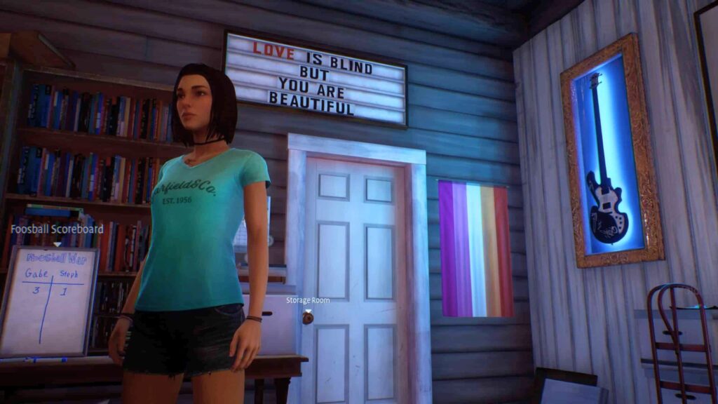 Steph arbore le drapeau de la communauté lesbienne dans son magasin de musique. // Source : Square Enix / Deck Nine Steph arbore le drapeau de la communauté lesbienne dans son magasin de musique. // Source : Square Enix / Deck Nine