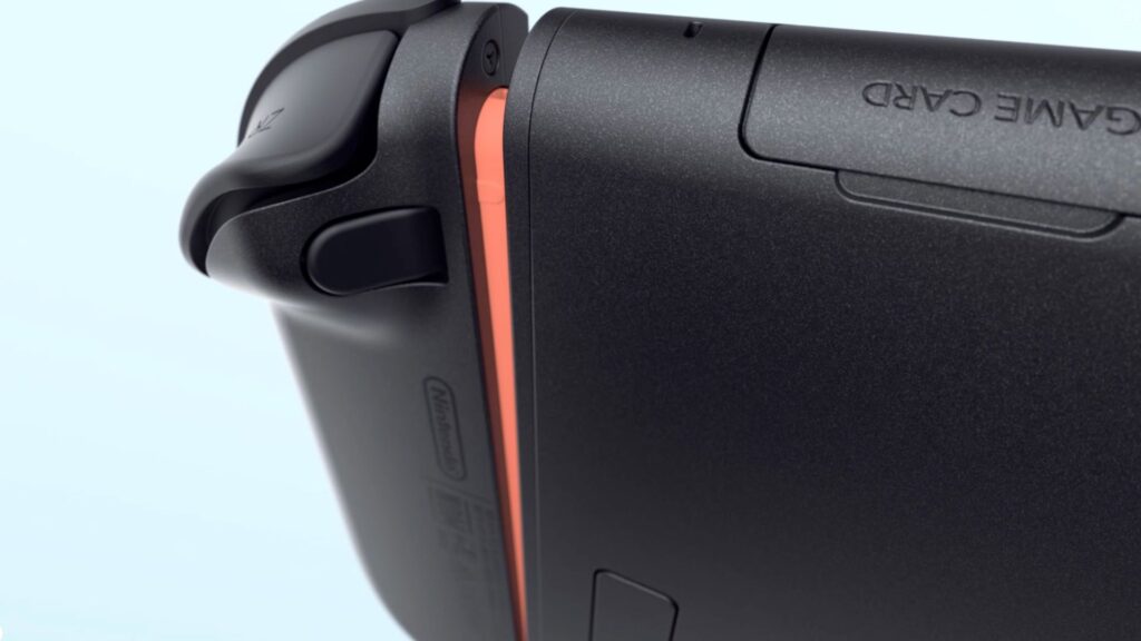 La Nintendo Switch 2 et le bouton du Joy-Con pour retirer l'aimant. // Source : Nintendo La Nintendo Switch 2 et le bouton du Joy-Con pour retirer l'aimant. // Source : Nintendo