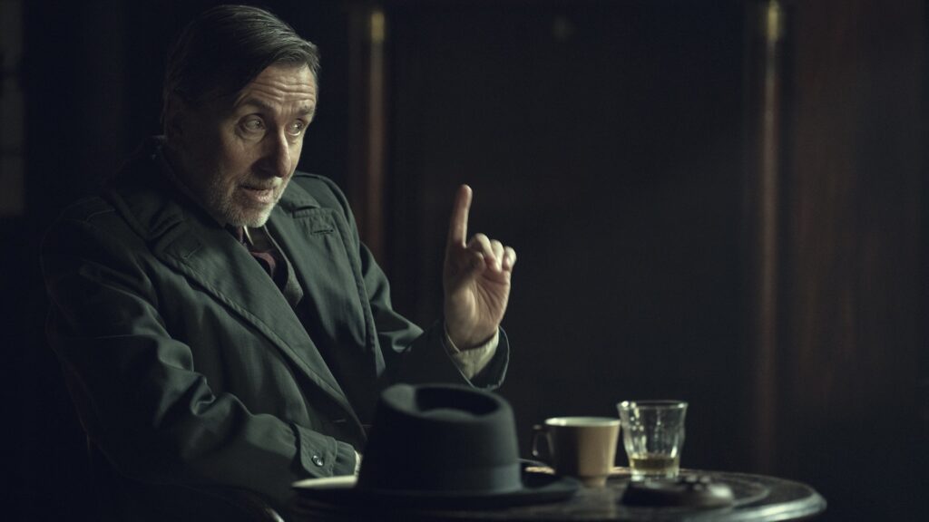 Peaky Blinders: The Immortal Man. Tim Roth as Beckett in Peaky Blinders: The Immortal Man. Cr. Robert Viglasky/Netflix © 2026. Peaky Blinders: The Immortal Man. Tim Roth as Beckett in Peaky Blinders: The Immortal Man. Cr. Robert Viglasky/Netflix © 2026.