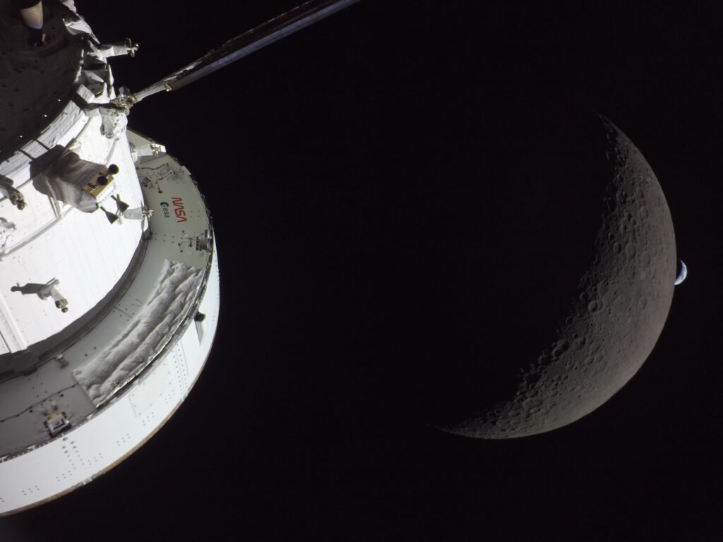 art002e009567 (April 6, 2026) - NASA’s Orion spacecraft captures the Moon and the Earth in one frame during the Artemis II crew’s deep space journey at 6:42 p.m. ET on the sixth day of the mission. The right side of NASA’s Orion spacecraft is seen lit up by the Sun. A waxing crescent Moon is visible behind it. And then, a crescent Earth, tiny compared to the Moon, is about to set below the Moon’s horizon on the right. Credit: NASA art002e009567 (April 6, 2026) - NASA’s Orion spacecraft captures the Moon and the Earth in one frame during the Artemis II crew’s deep space journey at 6:42 p.m. ET on the sixth day of the mission. The right side of NASA’s Orion spacecraft is seen lit up by the Sun. A waxing crescent Moon is visible behind it. And then, a crescent Earth, tiny compared to the Moon, is about to set below the Moon’s horizon on the right. Credit: NASA